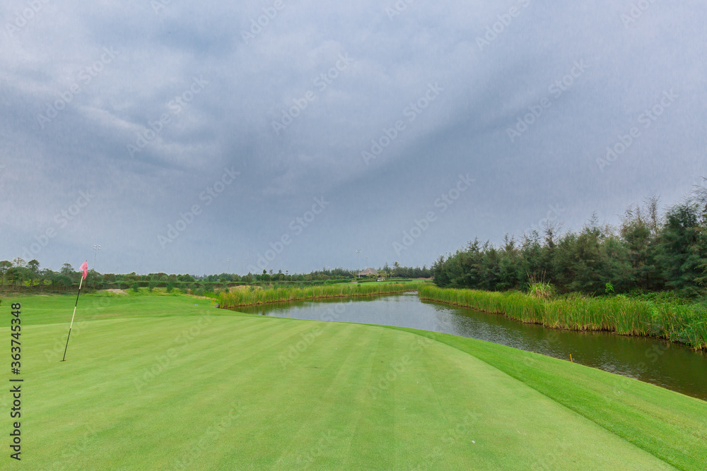 Empty golf course with lake view on a gloomy day Empty golf course with lake view on a gloomy day