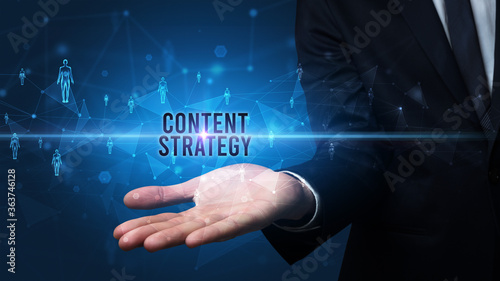 Elegant hand holding CONTENT STRATEGY inscription, social networking concept