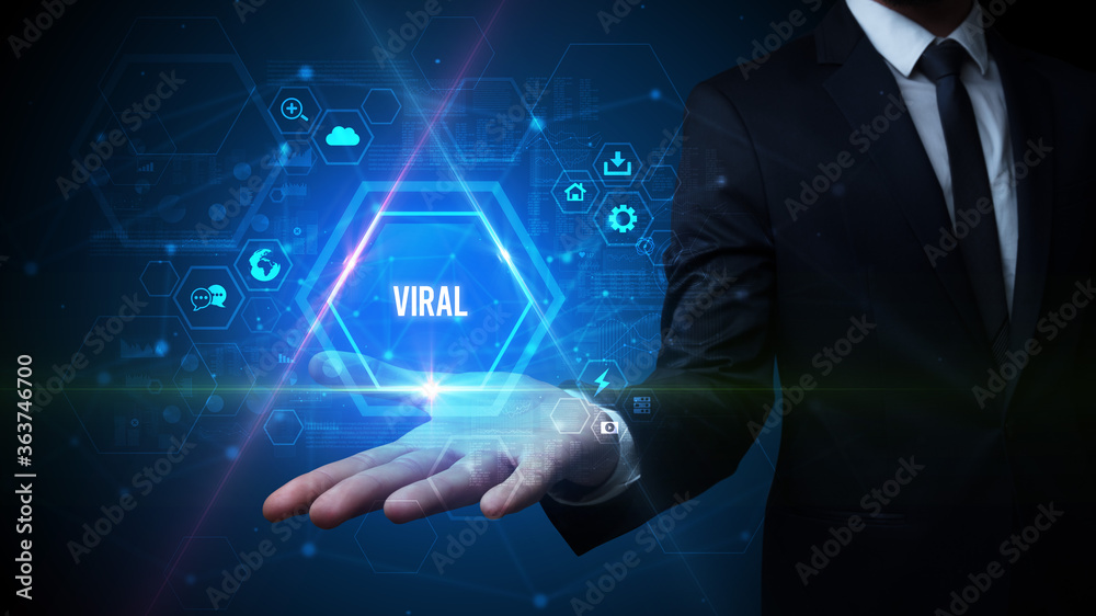 Man hand holding VIRAL inscription, social media concept Man hand holding VIRAL inscription, social media concept