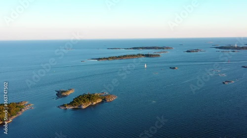 Aerial tracking drone shot of a Sail boat in the archipelago, driving between islands on the gulf of Finland, golden hour, in Porkkala, Uusimaa photo