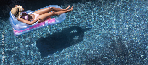 Woman floating on inflatable ring in the pool