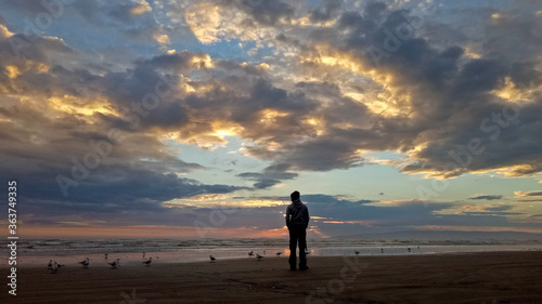 A man standing at Oretti beach Invercargill New Zealand photo