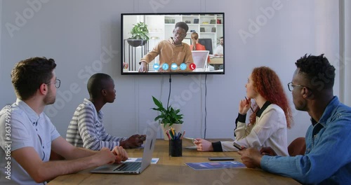 Creative business colleagues in video conference in meeting room in modern office photo