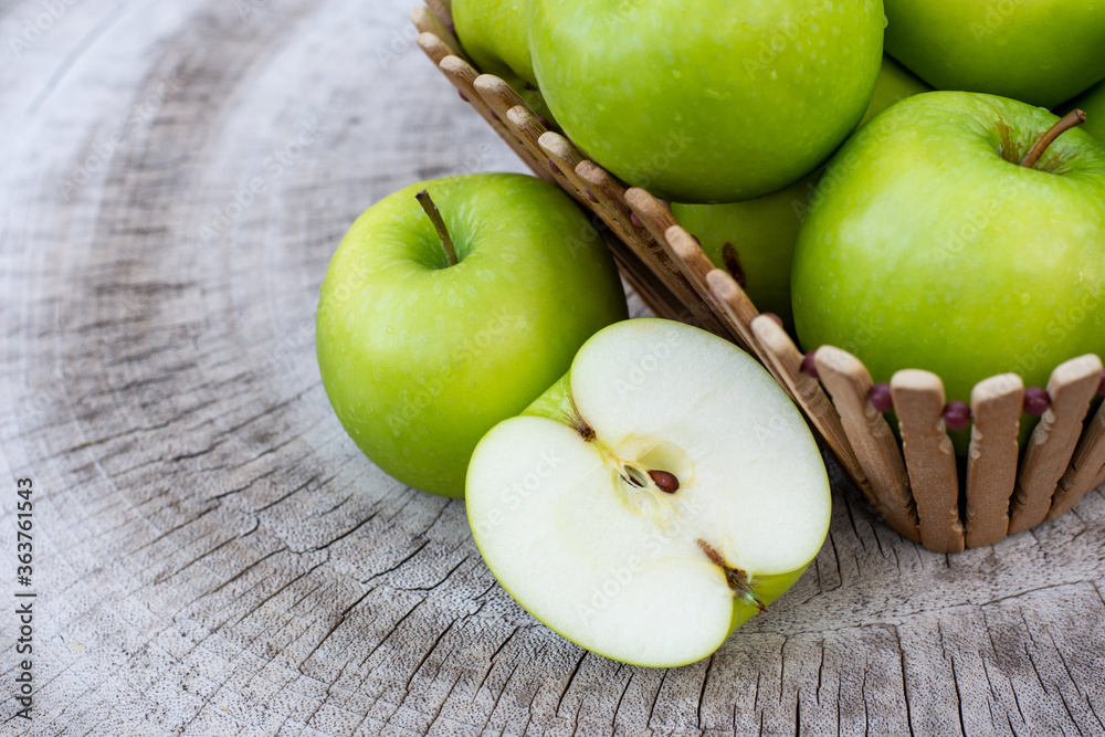 green apples with cut in half slice isolated on a wooden table green apples with cut in half slice isolated on a wooden table