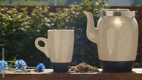 Teacup and teapot on the table in the garden