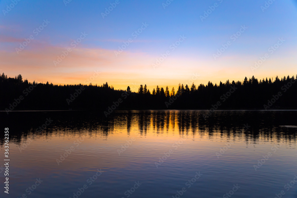 Colorful sunset reflection of forest on Sequoia lake