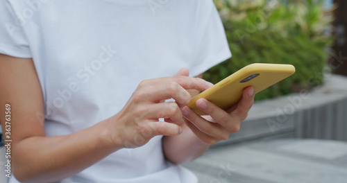 Photography Woman uses mobile phone at street