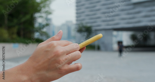 Canvas Print Woman uses mobile phone at street