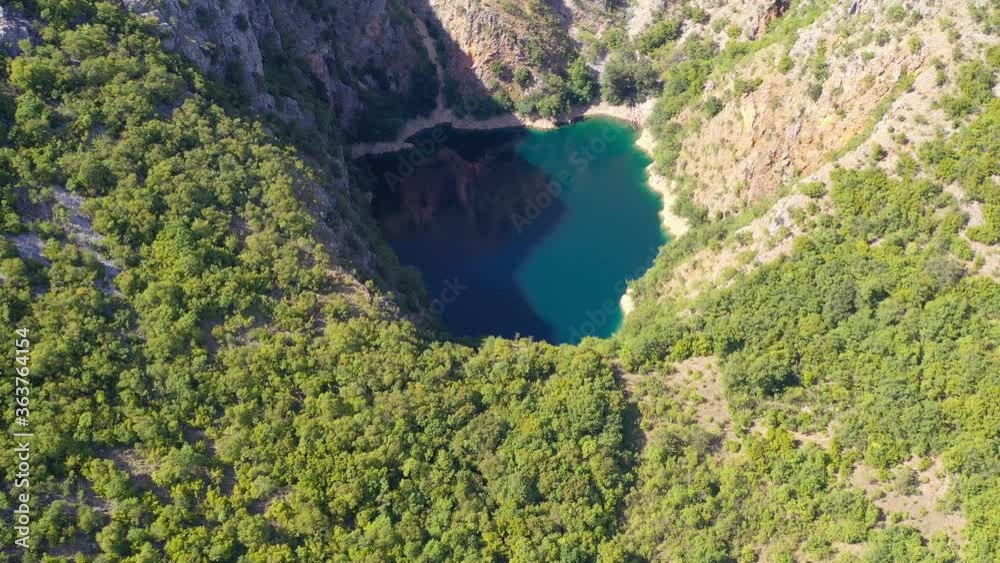 Blue Galjipovac Lake in Prolosko Blato marshes of Croatia inside the mountains, Aerial lowering view Blue Galjipovac Lake in Prolosko Blato marshes of Croatia inside the mountains, Aerial lowering view