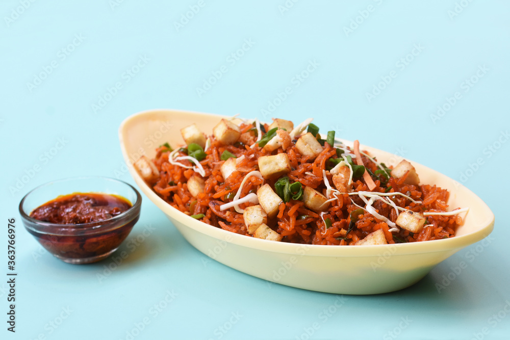 Schezwan paneer fried rice with schezwan sauce,Chinese fried rice with paneer,indo-chinese cuisine dishes. selective focus Schezwan paneer fried rice with schezwan sauce,Chinese fried rice with paneer,indo-chinese cuisine dishes. selective focus