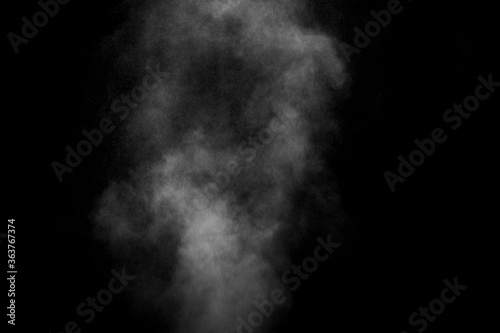 Abstract steam with dots of spray moves on a black background. Figured smoke can be used for design