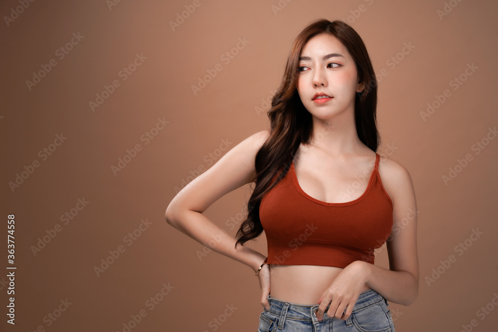 Slim body and big breast asian woman looking and arms akimbo, Red