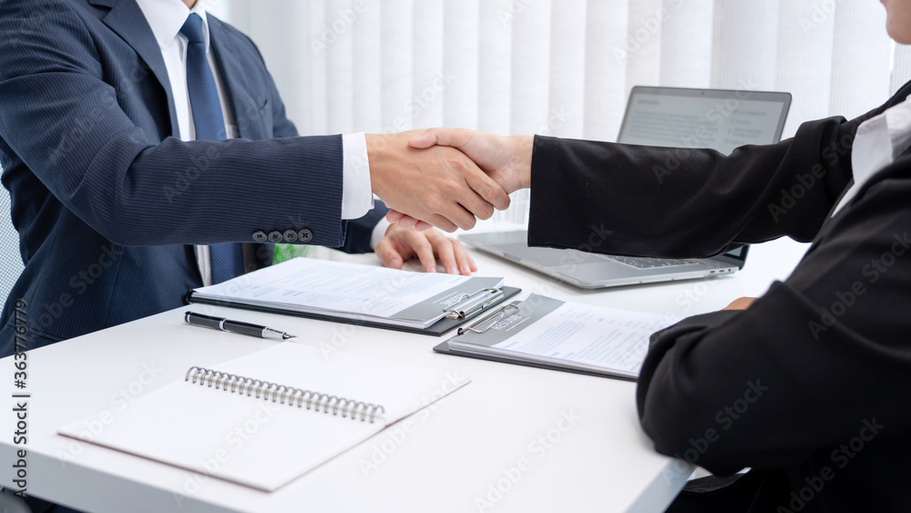 two business people shaking hands of Candidate asian businesswoman after successful negotiations or interview, career and placement concept. two business people shaking hands of Candidate asian businesswoman after successful negotiations or interview, career and placement concept.