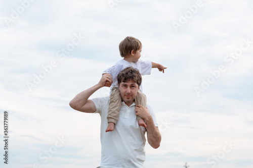 Father and little son walking in the field