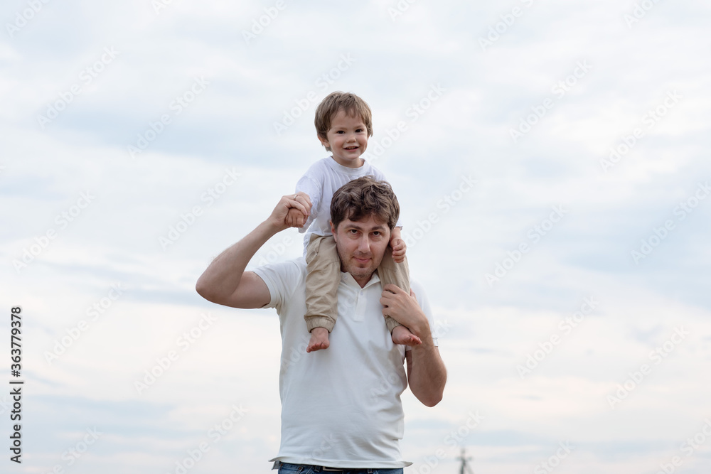 Father and little son walking in the field Father and little son walking in the field
