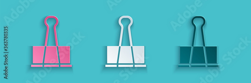 Paper cut Binder clip icon isolated on blue background. Paper clip. Paper art style. Vector Illustration.
