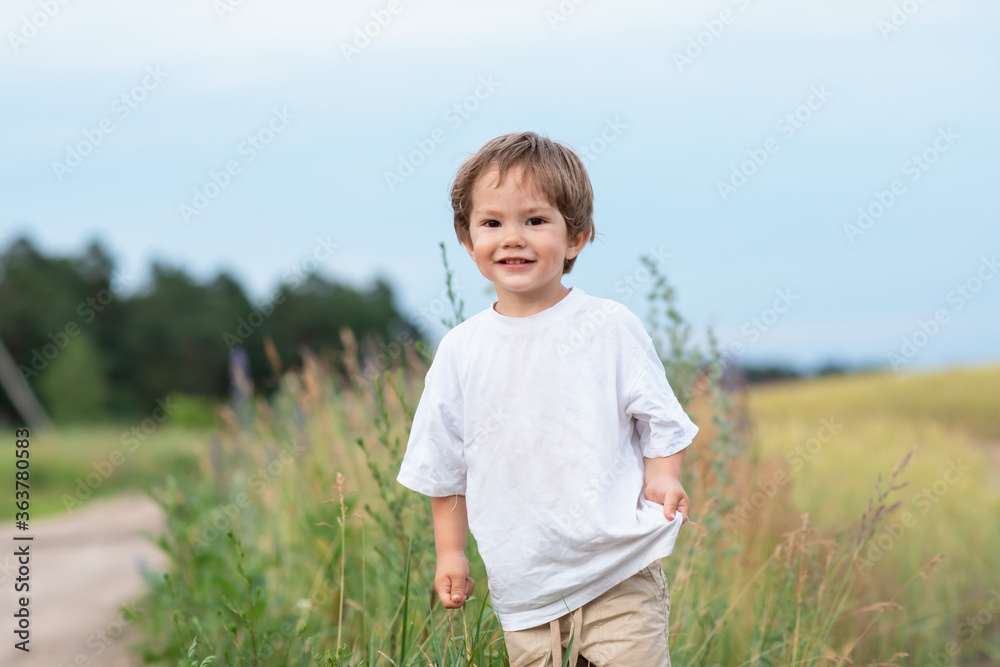 The little boy is making his way through the grass The little boy is making his way through the grass
