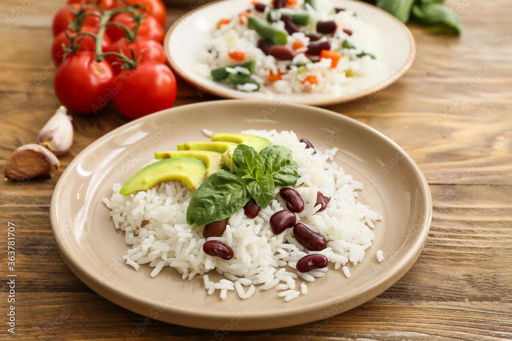 Plate with tasty rice, beans and avocado on table Plate with tasty rice, beans and avocado on table