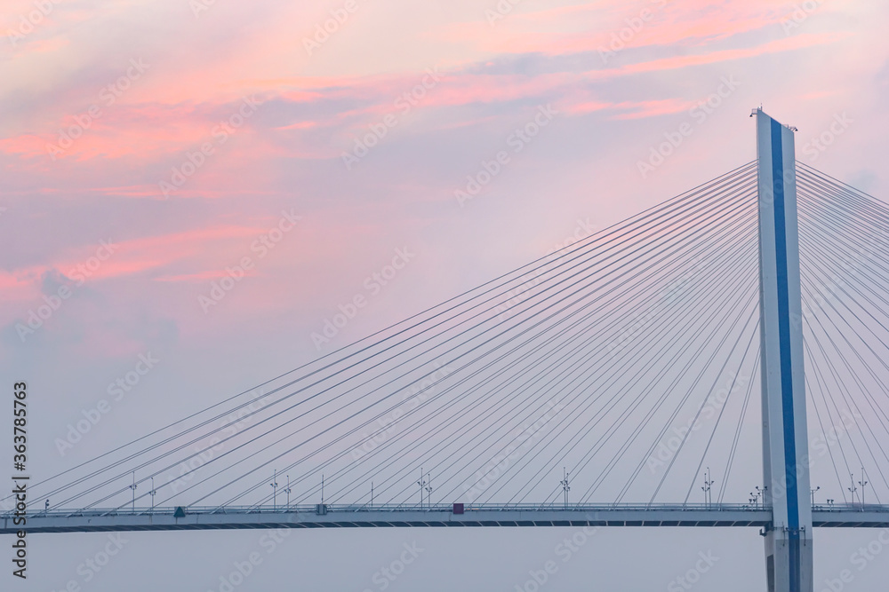 A bridge crosses the sea at sunrise and sunset in hainan, China.