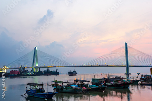 A bridge crosses the sea at sunrise and sunset in hainan, China. © 一飞 黄