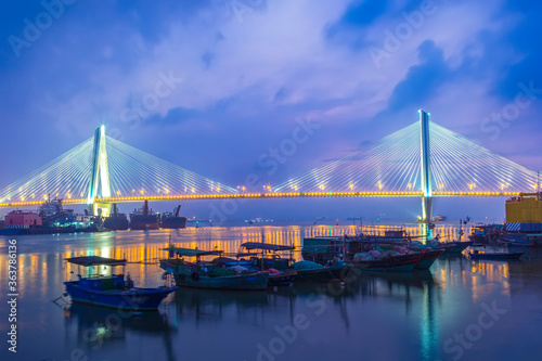 A bridge crosses the sea at night in hainan, China.