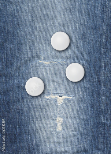 Three badges on a blue denim background photo