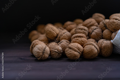 Ripe walnuts on a wooden background