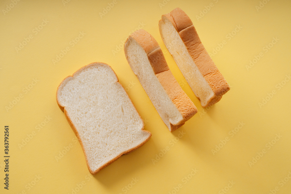 Home made organic sliced bread over yellow background. Home made organic sliced bread over yellow background.