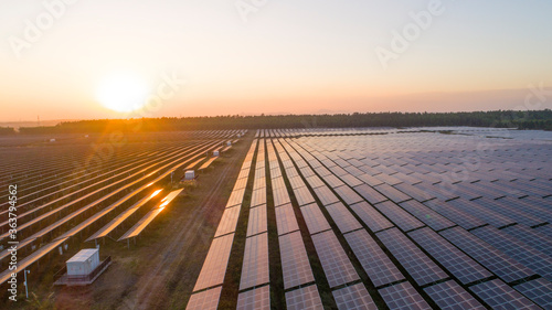 Photovoltaic solar panels at sunrise and sunset.