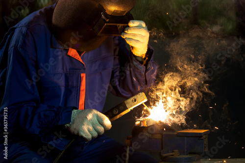 Industry worker mechanic welding iron at industrial factory