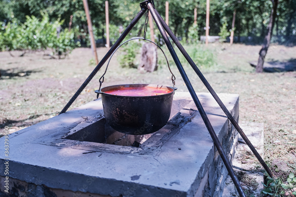 A little stick hanging on a fire on a trine on fire and preparing food A little stick hanging on a fire on a trine on fire and preparing food