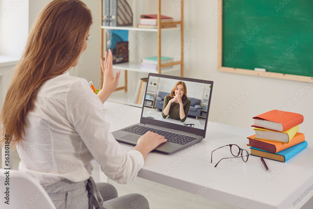 Online education. Teacher talks with student using laptop webcam in class. Online education. Teacher talks with student using laptop webcam in class.