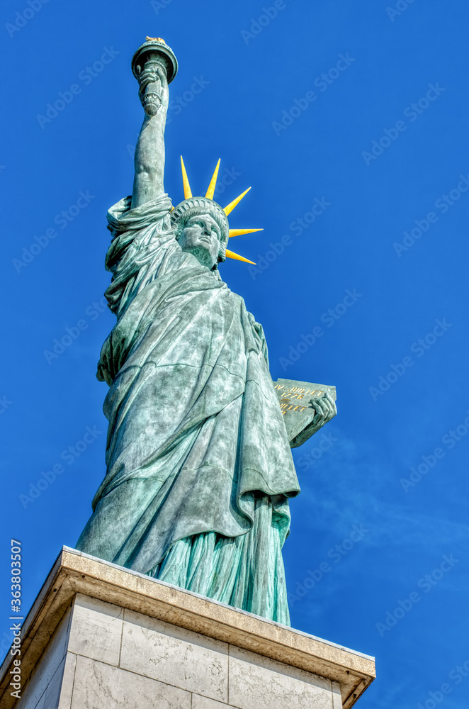 Fototapeta premium Famous Statue de la liberte on a bright day of February - Paris, France. This statue was given in 1889 to France by U.S. citizens living in Paris.