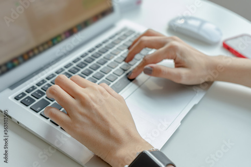 Woman hands typing on laptop keyboard at the office, Woman worker and business concept, Soft focus © Ardianto
