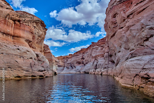 View of narrow, cliff-lined canyon from a boat in Glen Canyon National Recreation Area, Lake Powell, Arizona