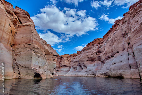 View of narrow, cliff-lined canyon from a boat in Glen Canyon National Recreation Area, Lake Powell, Arizona