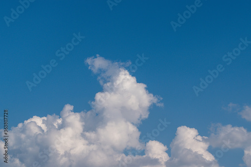 Dense billowing cloud on a background of blue sky
