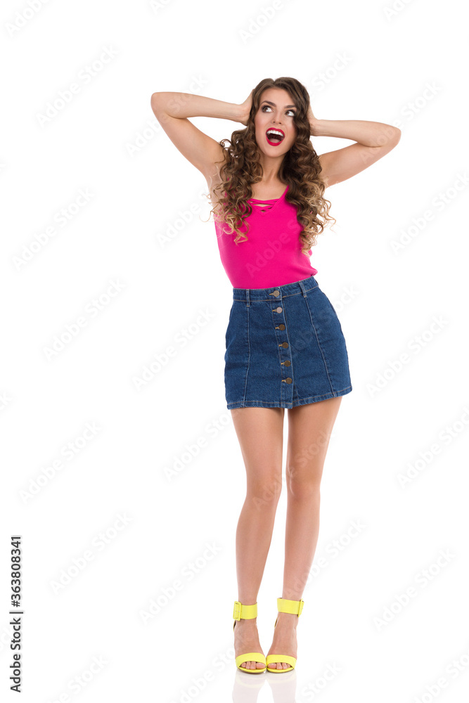 Surprised Young Woman In Mini Skirt And High Heels Is Holding Head In Hands And Shouting Surprised Young Woman In Mini Skirt And High Heels Is Holding Head In Hands And Shouting