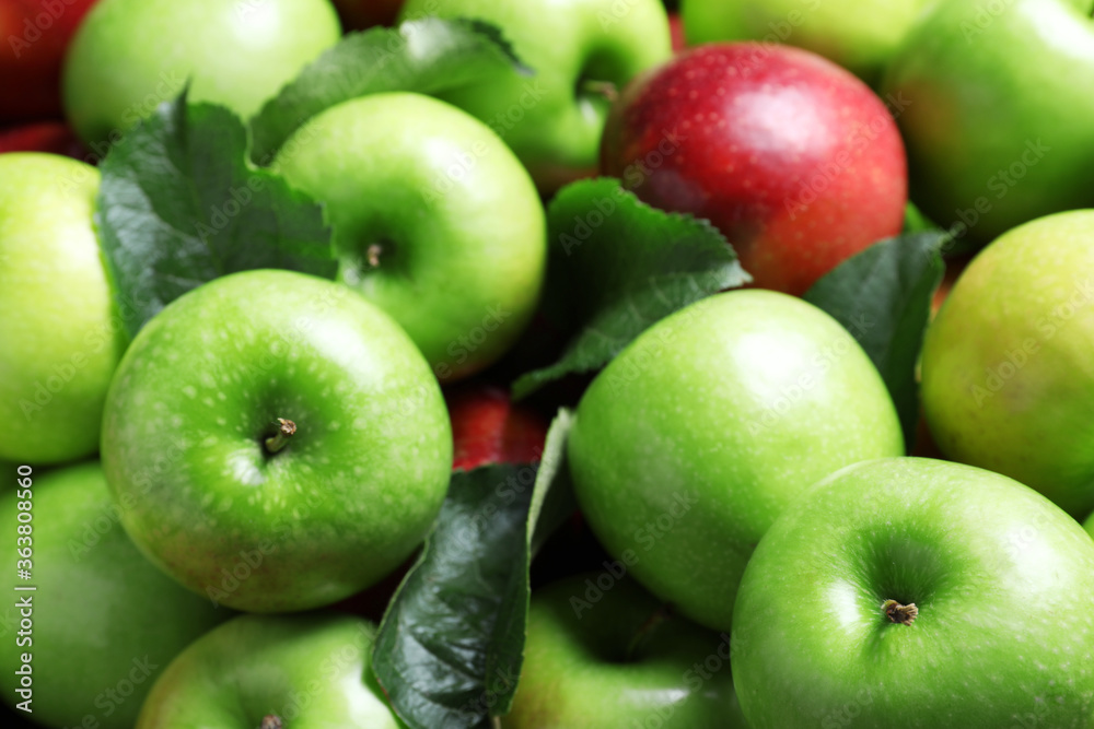 Pile of tasty ripe apples with leaves as background, closeup Pile of tasty ripe apples with leaves as background, closeup