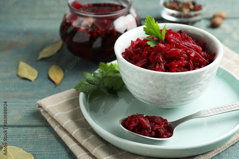 Bowl with delicious pickled beets on blue wooden table Bowl with delicious pickled beets on blue wooden table