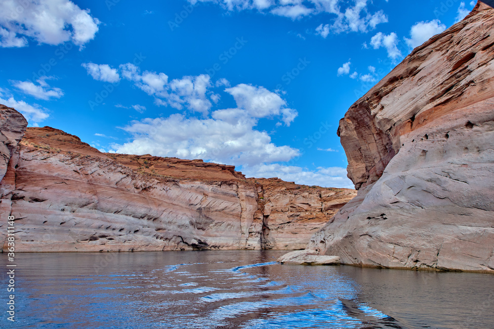 View of narrow, cliff-lined canyon from a boat in Glen Canyon National Recreation Area, Lake Powell, Arizona