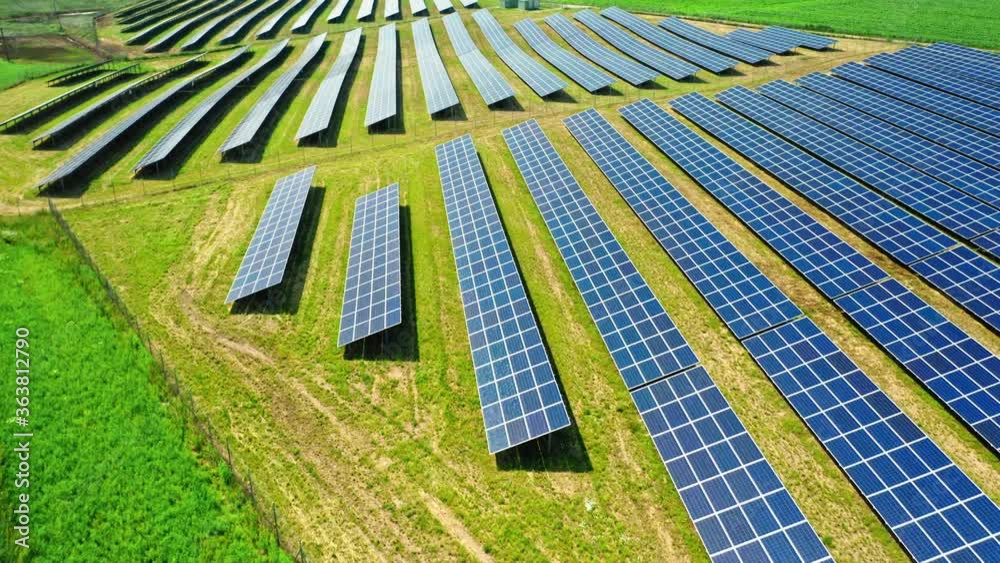 Stunning aerial view of solar panels on green field