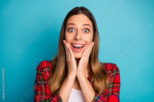 Close-up portrait of nice attractive pretty lovely amazed funny cheerful cheery long-haired girl wearing checked shirt great news reaction isolated on bright vivid shine vibrant blue color background