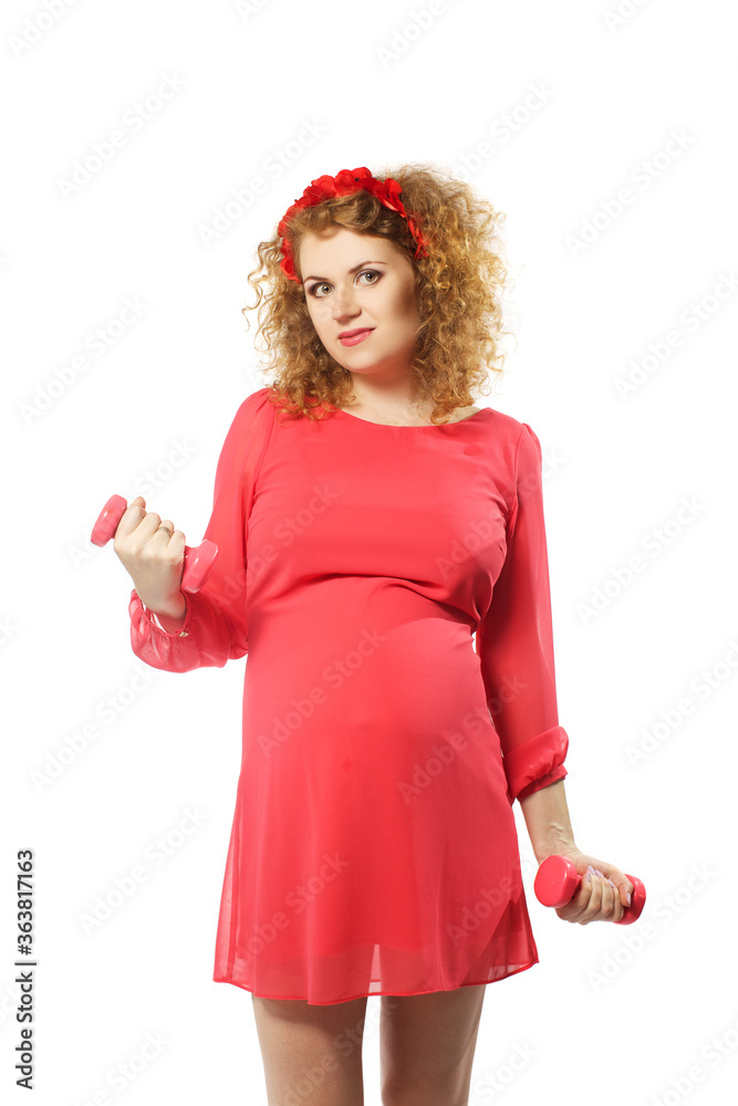 Cute caucasian adult pregnat woman in red dress with dumbbells isolated on white background Cute caucasian adult pregnat woman in red dress with dumbbells isolated on white background