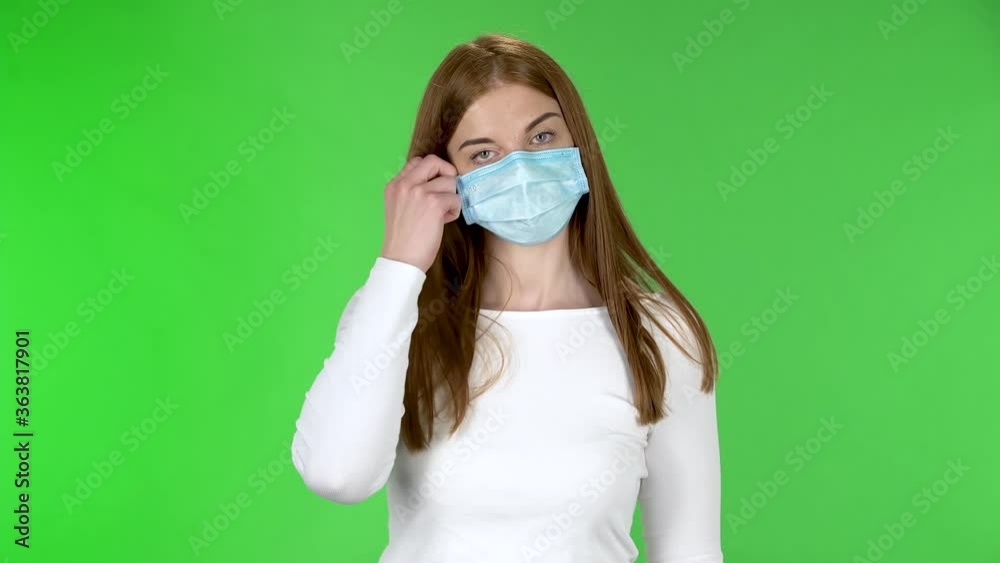 Portrait of young girl removes medical protective mask and breathes air. Portrait of young girl removes medical protective mask and breathes air.