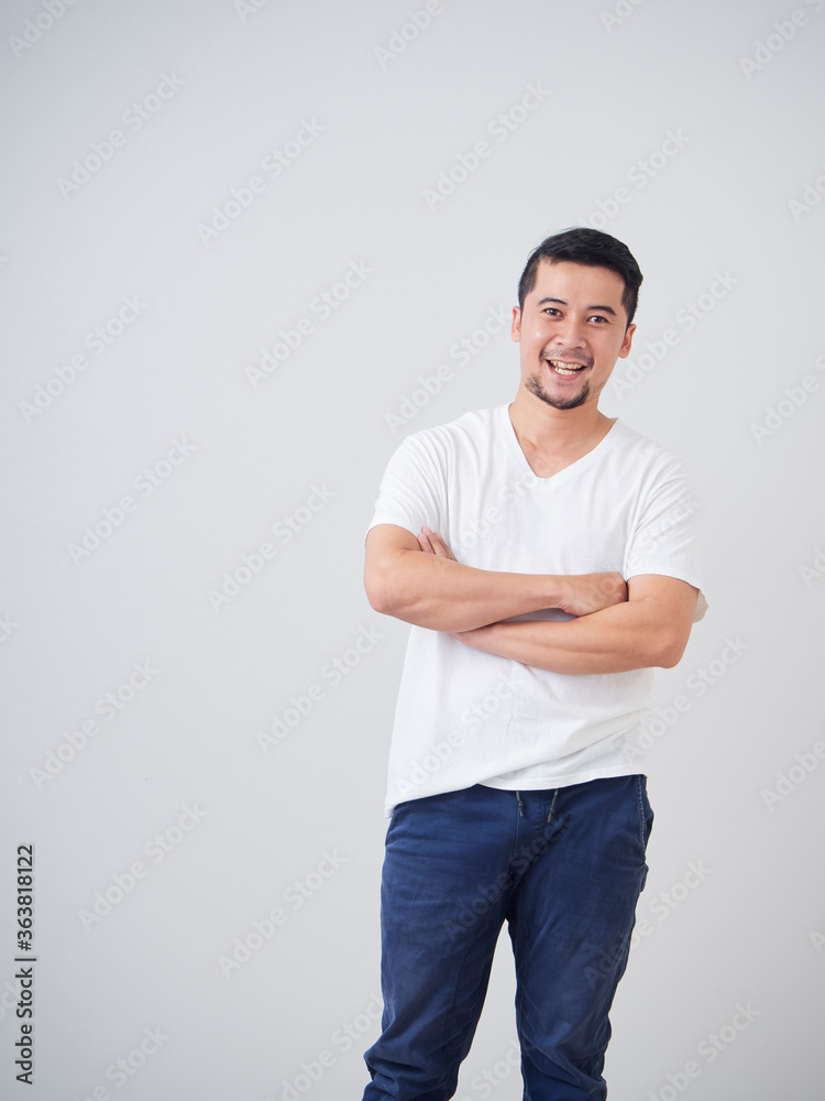 Young man crossed arms while standing. Young man crossed arms while standing.
