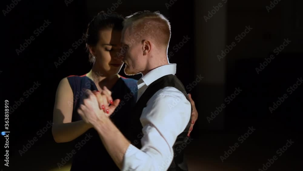 A man and a woman dancing tango. Beautiful light, professional dancers. A man and a woman dancing tango. Beautiful light, professional dancers.