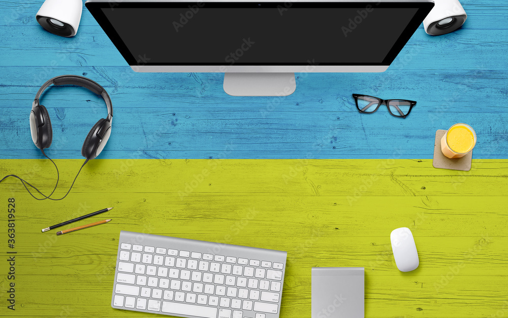 Ukraine flag background with headphone,computer keyboard and mouse on national office desk table.Top view with copy space.Flat Lay.