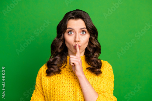 Portrait of impressed astonished girl hear confidential novelty ask dont share secret put index finger lips wear knitted pullover isolated over bright shine color background