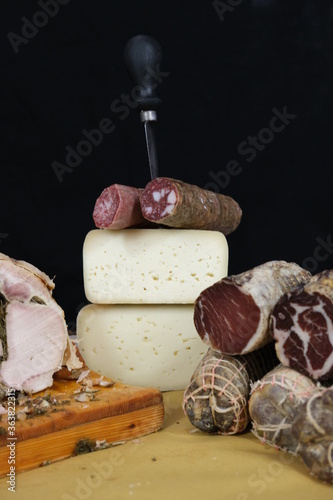 Tavolo con salumi e norcineria. Salame, prosciutto, porchetta, formaggio, lonza, lonzino, galantina photo